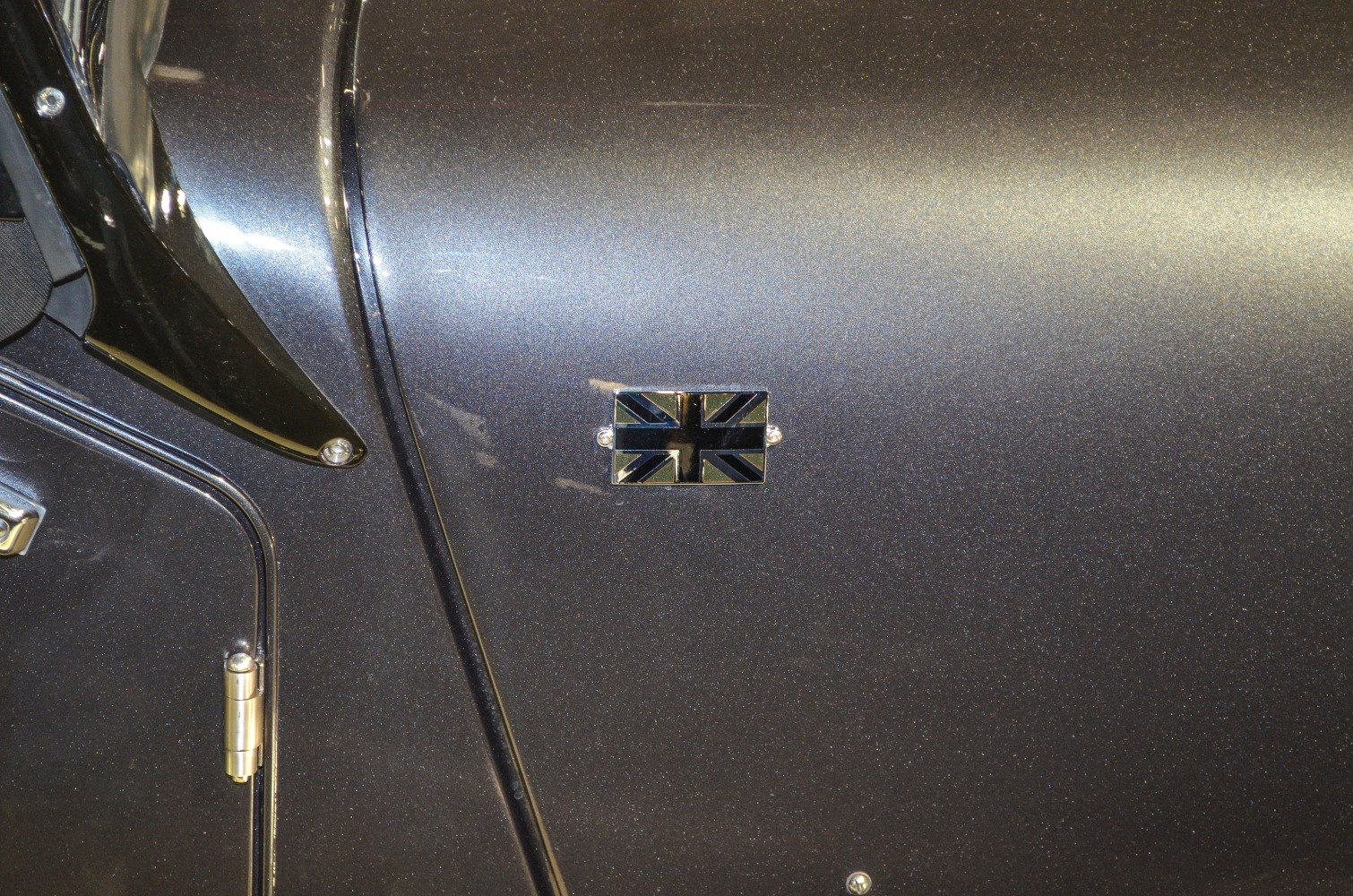 Close-up of British flag emblem on metallic car door panel