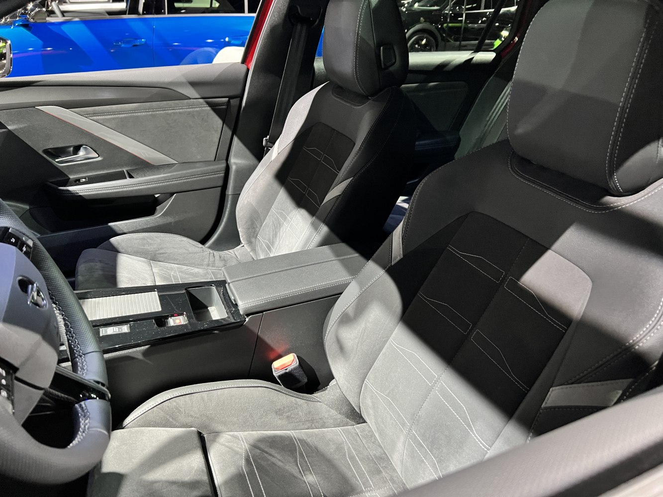 Front seats and door panel with detailed stitching and armrest