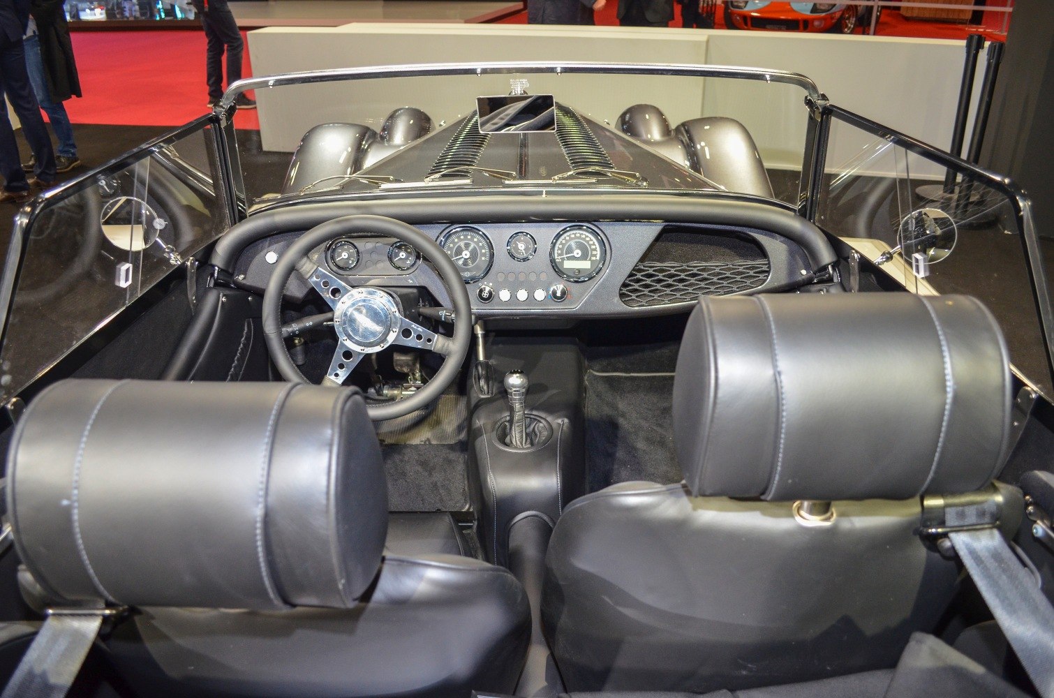 Vintage-style dashboard and leather seats interior with manual gear stick.