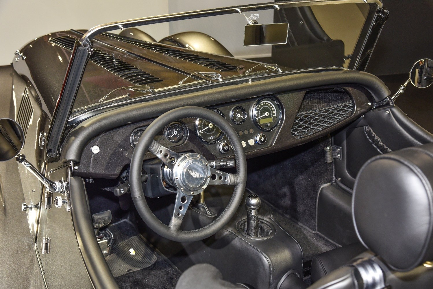 Black leather interior with classic dashboard and steering wheel