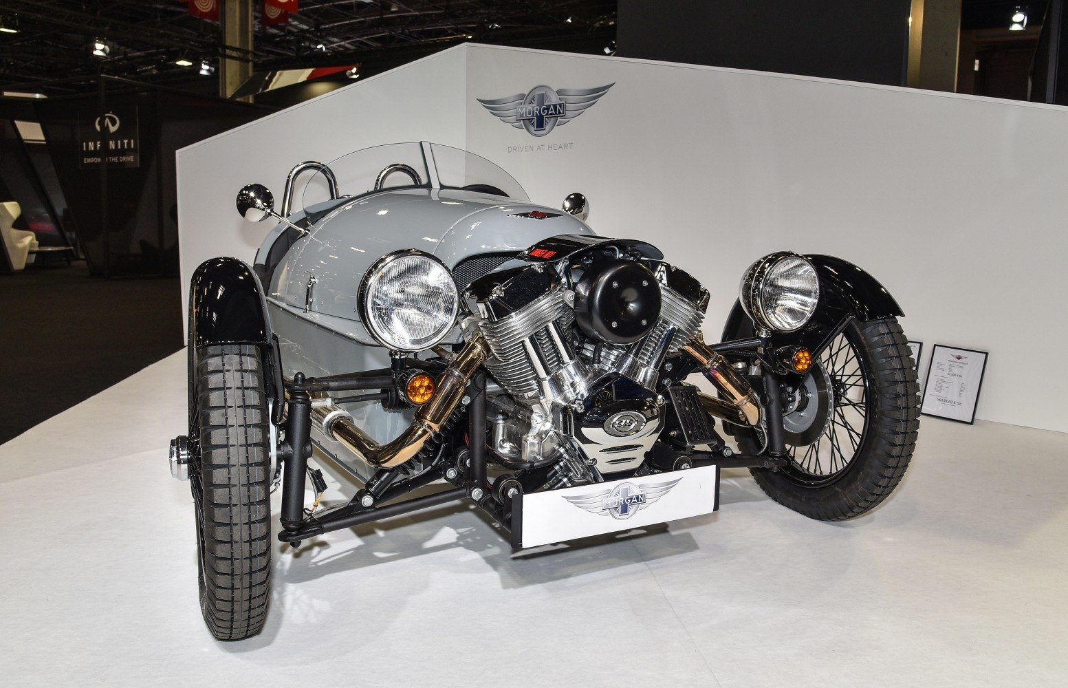 Exposed front V-twin engine and three-wheel layout with open cockpit