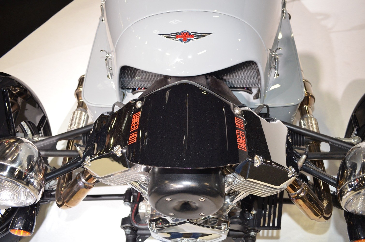 Exposed engine and front suspension with motorcycle headlights