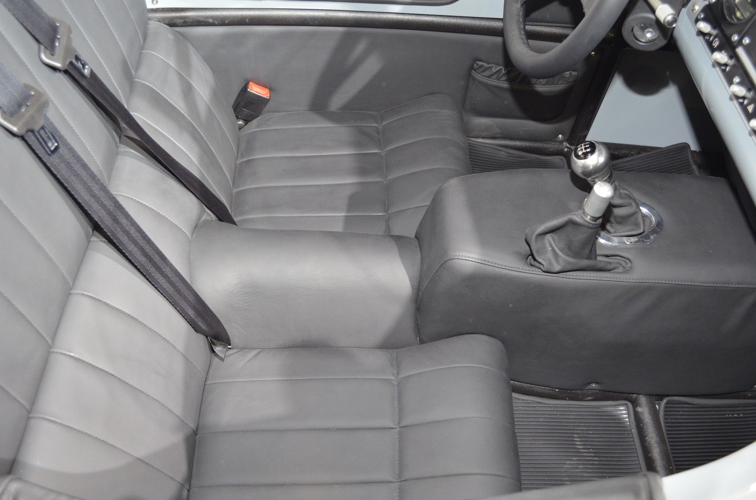 Leather seats and manual gear shifter of a classic vehicle interior