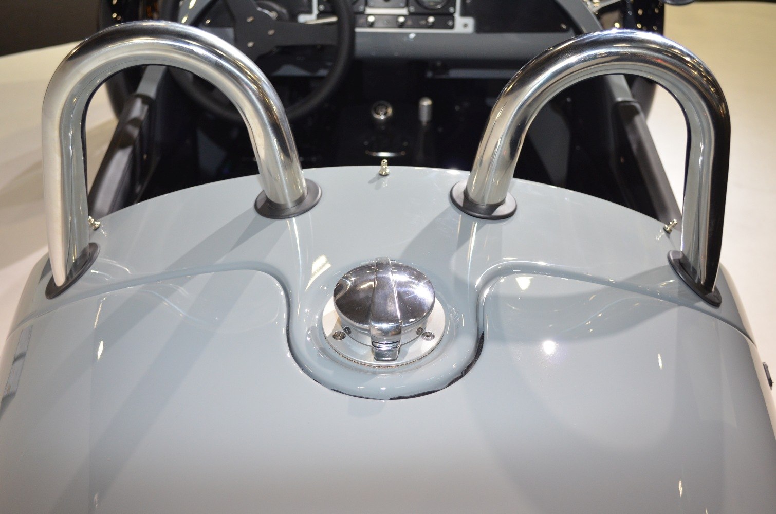 Chrome roll bars and central fuel cap on glossy surface