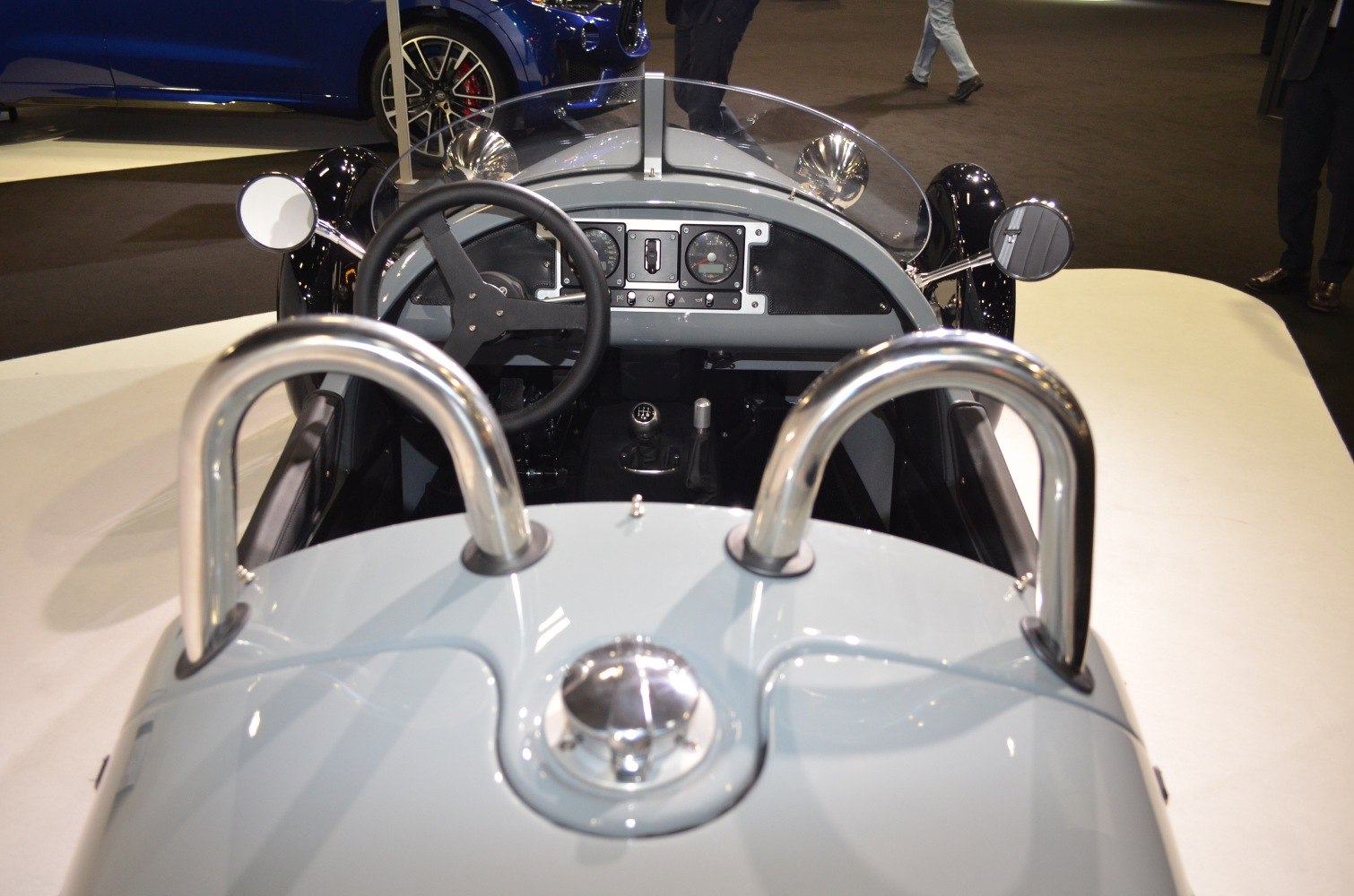 Open cockpit dashboard with steering wheel and chrome roll bars