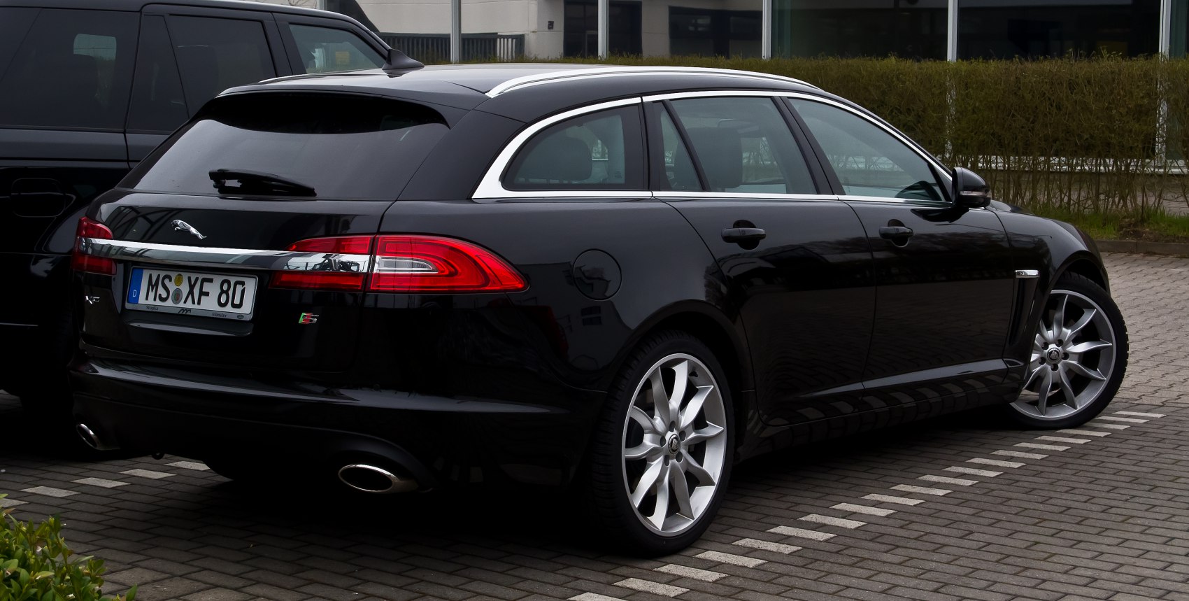Rear view of luxury station wagon with sporty alloy wheels and sleek rear taillights