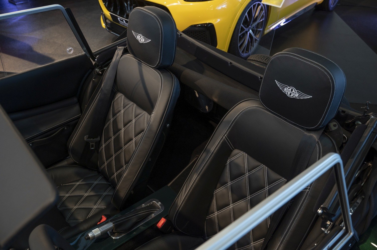 Black leather seats with diamond stitching and logo embroidery.