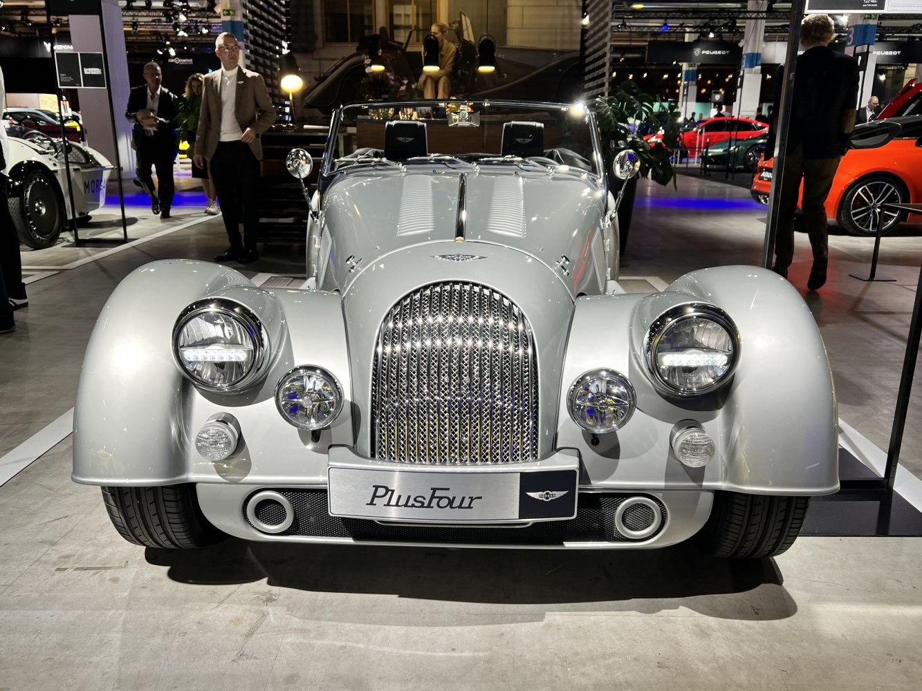 Front view of classic retro-style roadster with distinctive grille and round headlights