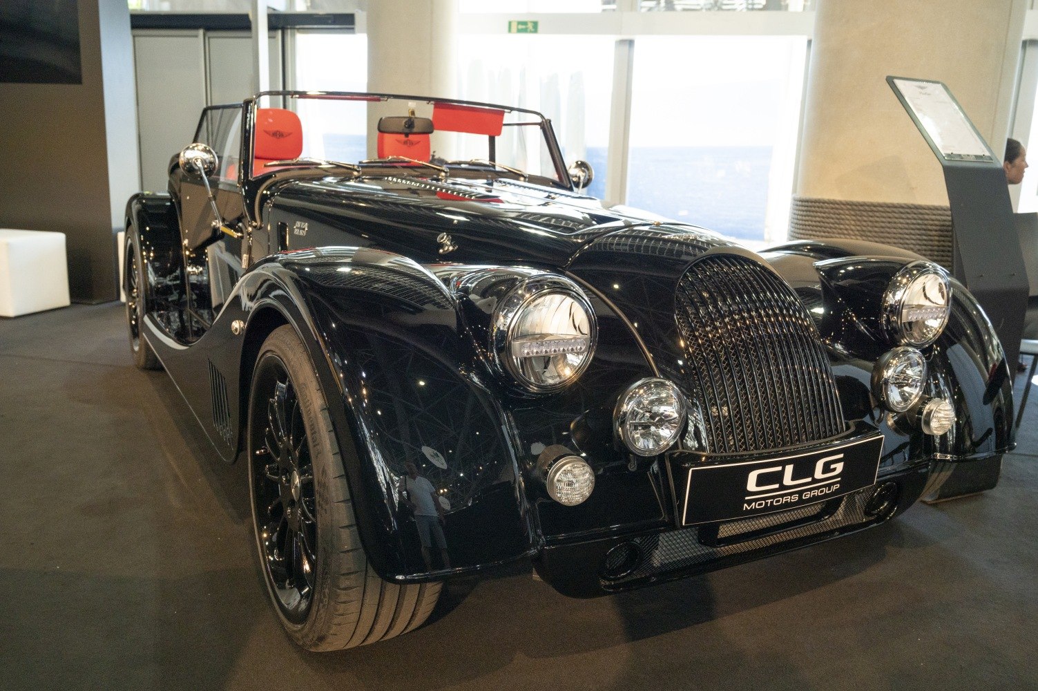 Classic open-top sports car with round headlights and distinctive grille.