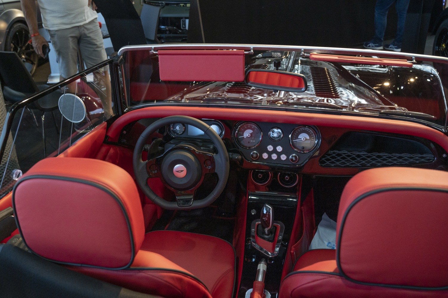 Red leather interior and classic dashboard with analog gauges and modern controls