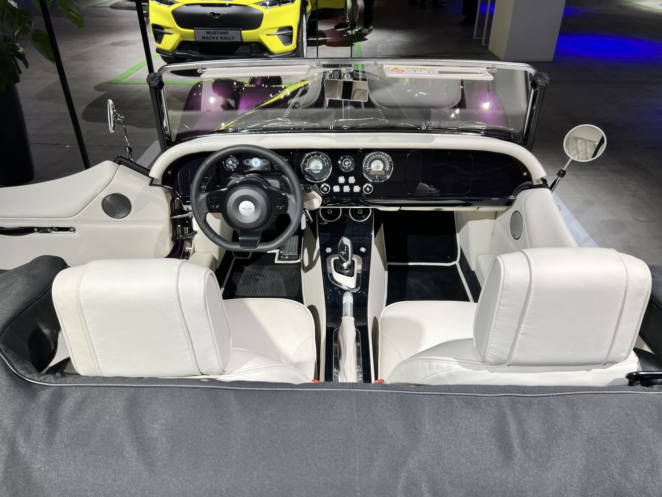 Classic dashboard and white leather seats in convertible interior