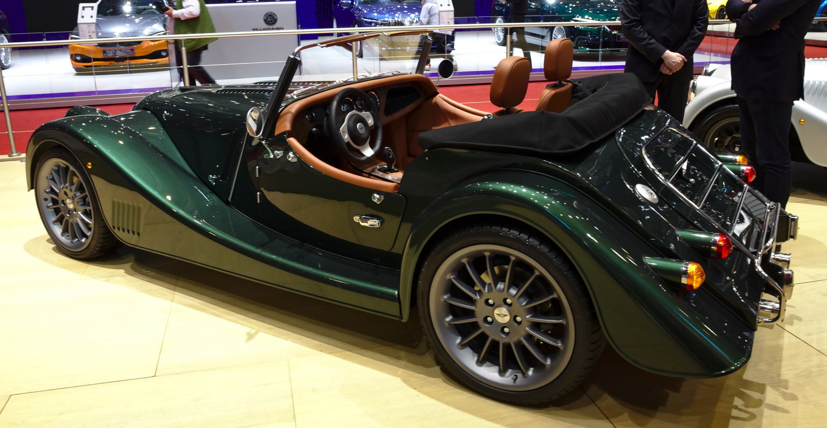 Retro-style open-top roadster with brown leather seats and green body