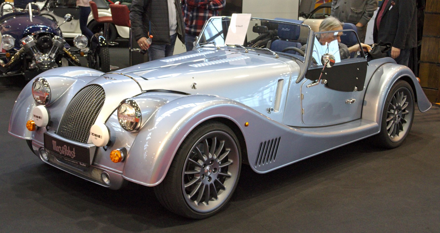Convertible car with classic front grille and multi-spoke alloy wheels