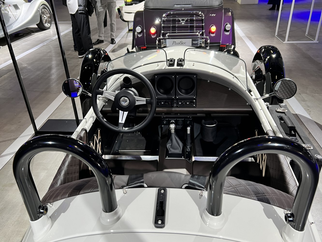 Minimalist retro dashboard and steering wheel with side mirrors.