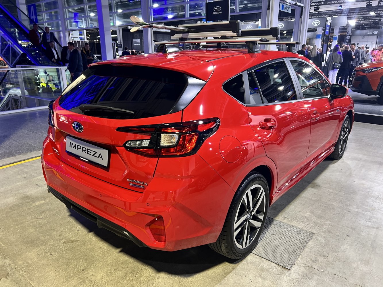 Rear view of hatchback with roof rack and sporty alloy wheels