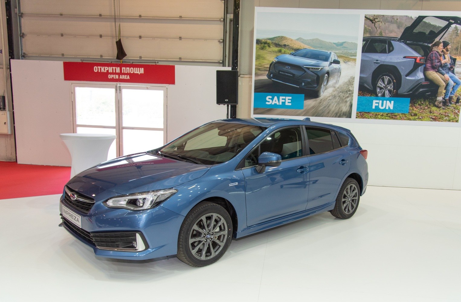 Side front view of a blue hatchback with alloy wheels