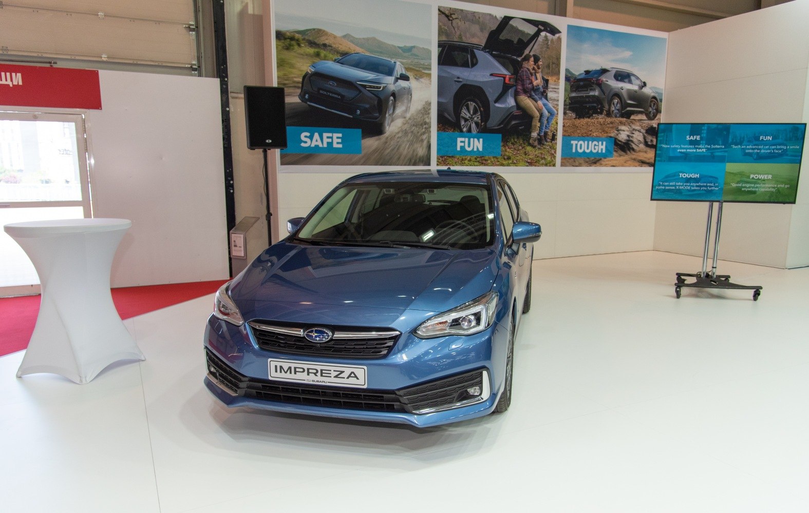Front view of blue hatchback with modern headlights and grille