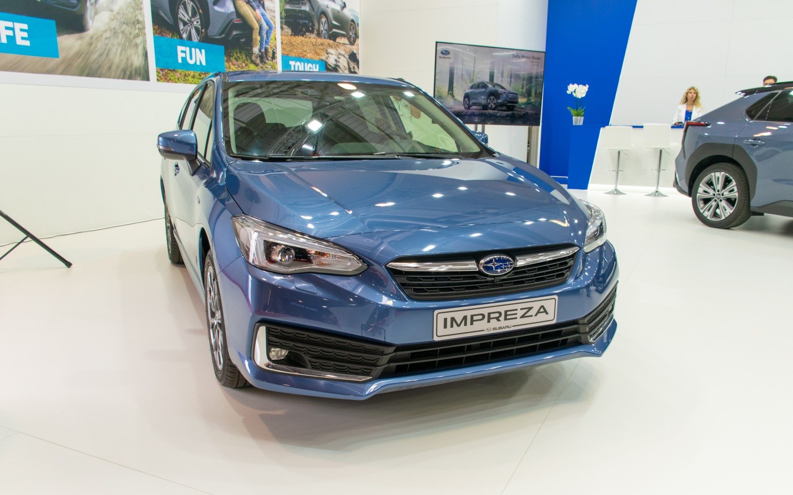 Sleek hatchback front with distinctive headlights and grille