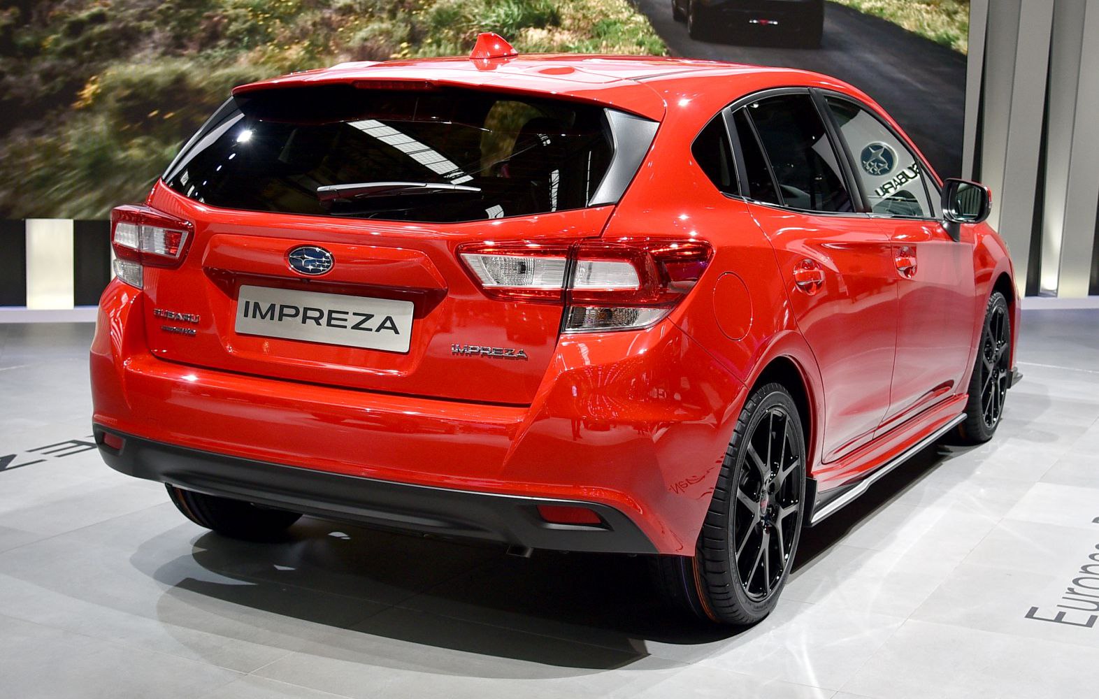 Rear view of a hatchback with taillights and black alloy wheels