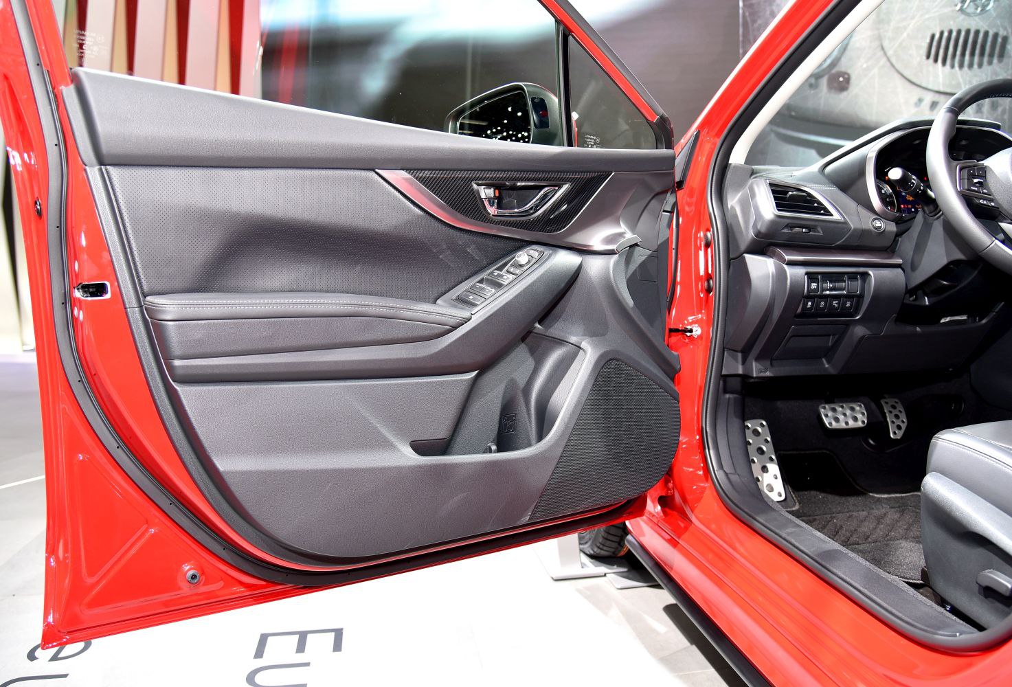 Interior door panel with control buttons and sporty pedals