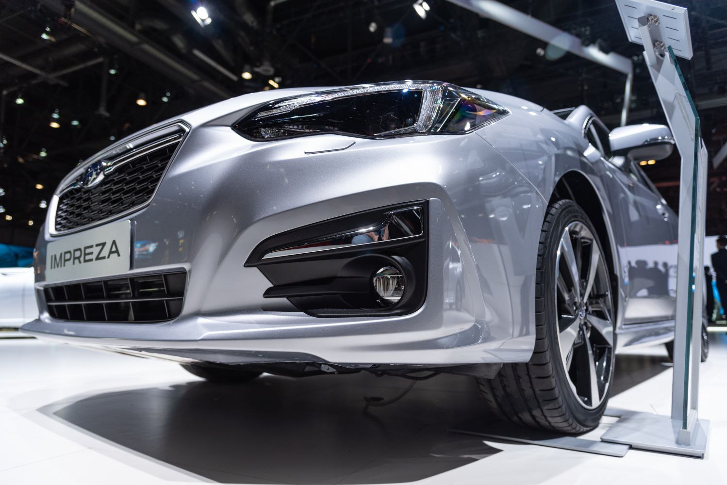 Close-up of front end with headlight and alloy wheel
