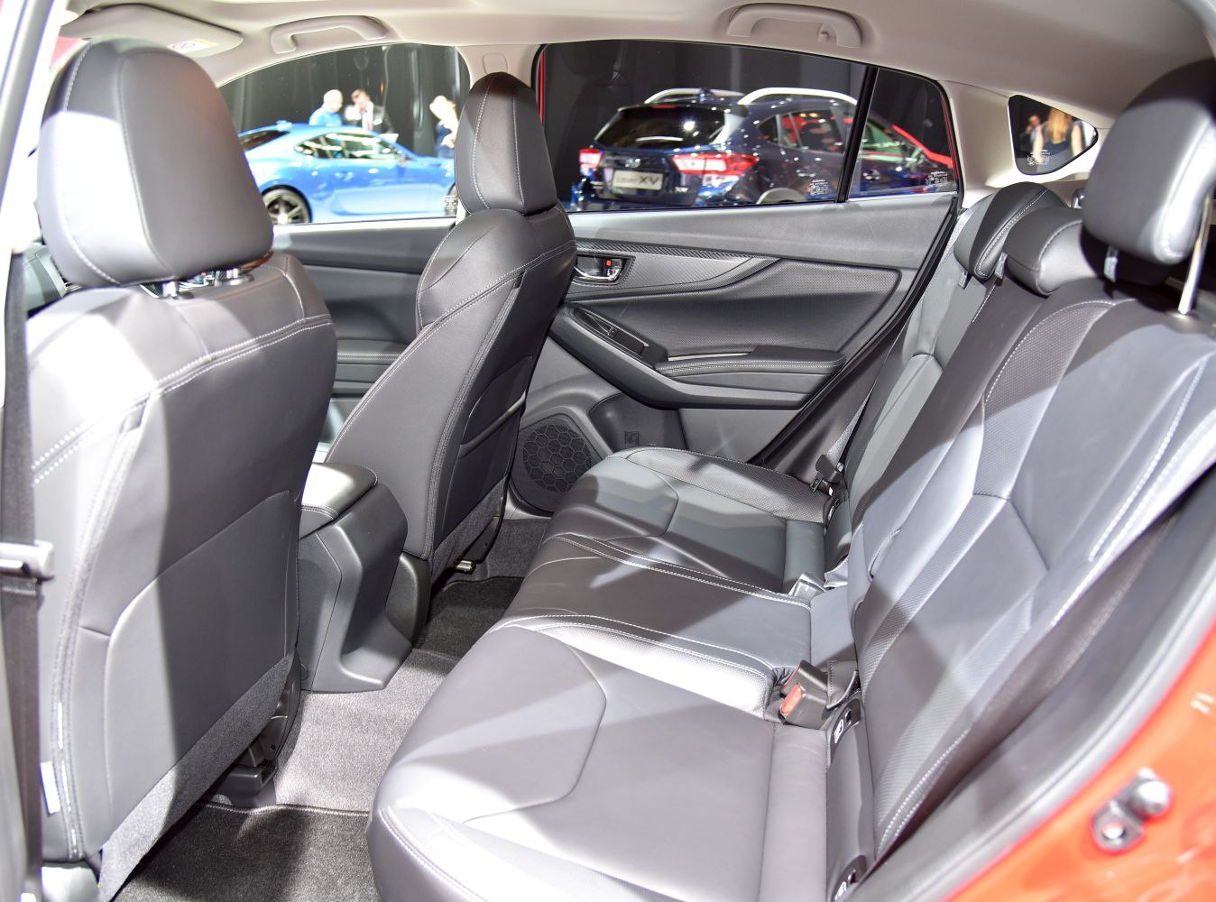 Rear passenger seat interior with door panel and black leather upholstery