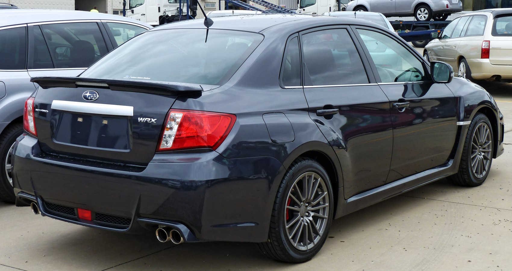 Sedan rear and side view with spoiler and quad exhaust