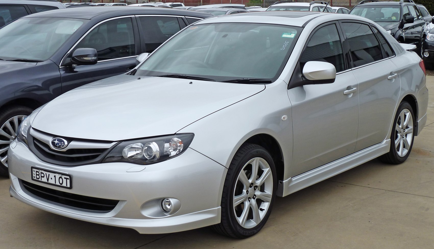 Silver sedan front side view with alloy wheels and fog lights
