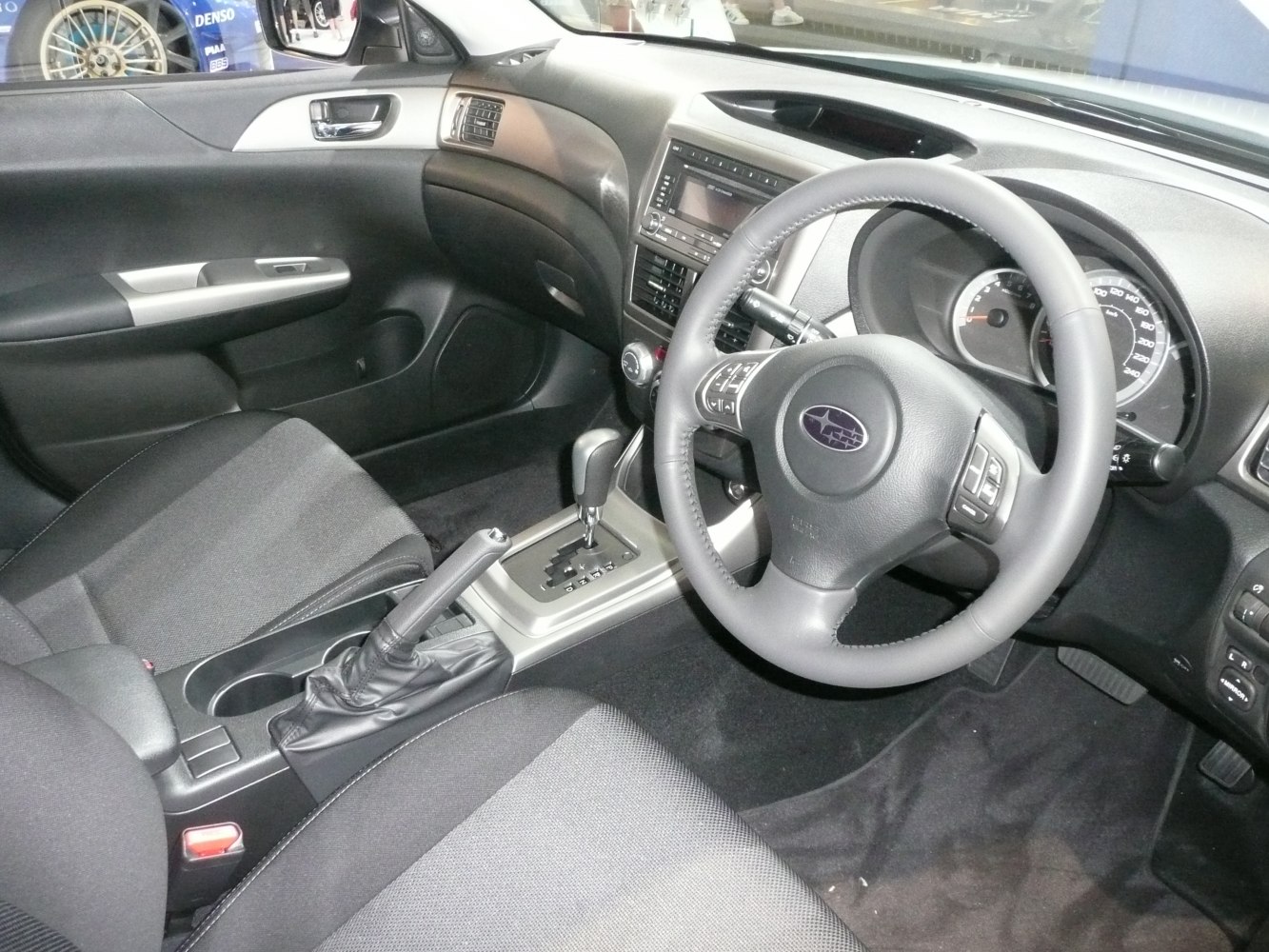 Steering wheel with controls and automatic gear shift in sedan interior