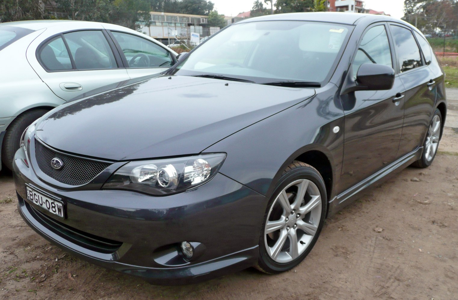 Front side view of hatchback with sleek headlights and alloy wheels