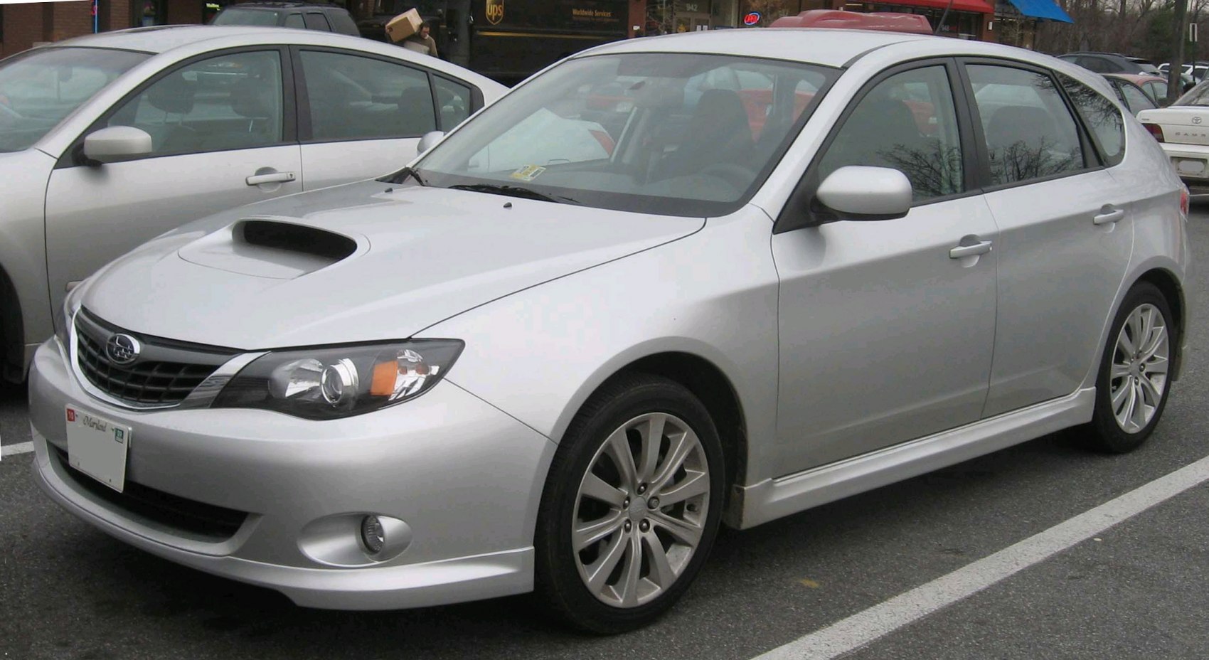 Silver hatchback with hood scoop and multi-spoke alloy wheels