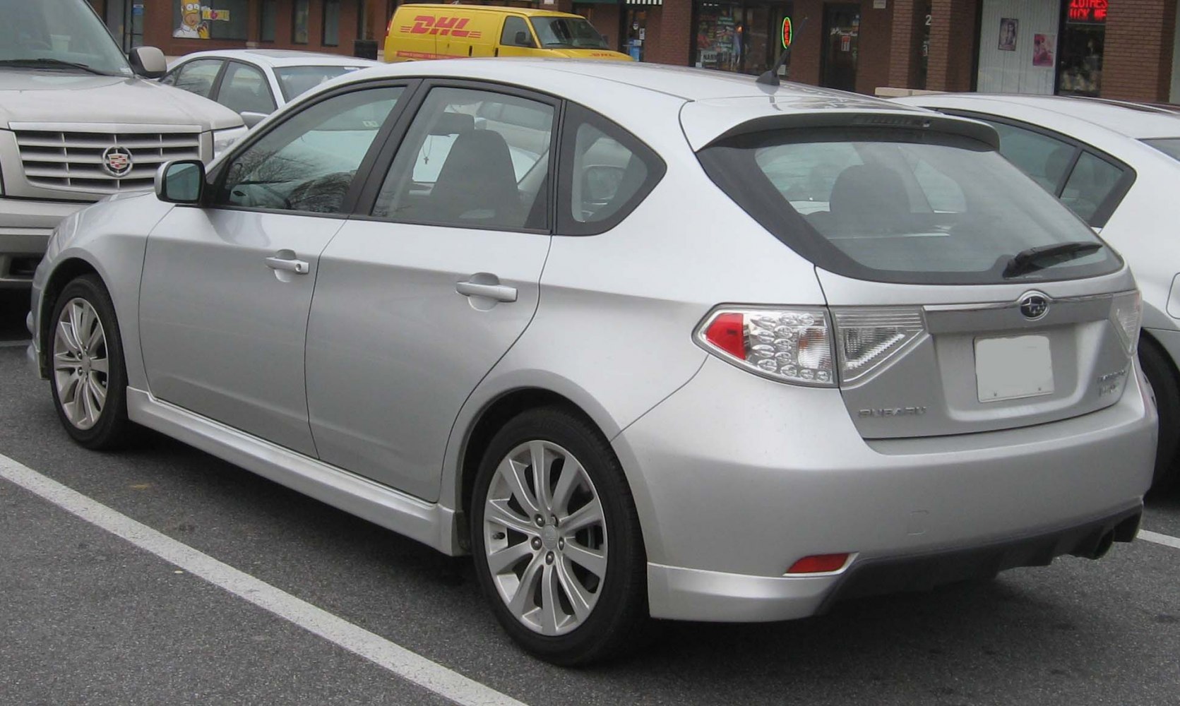Rear and side view of silver hatchback with alloy wheels