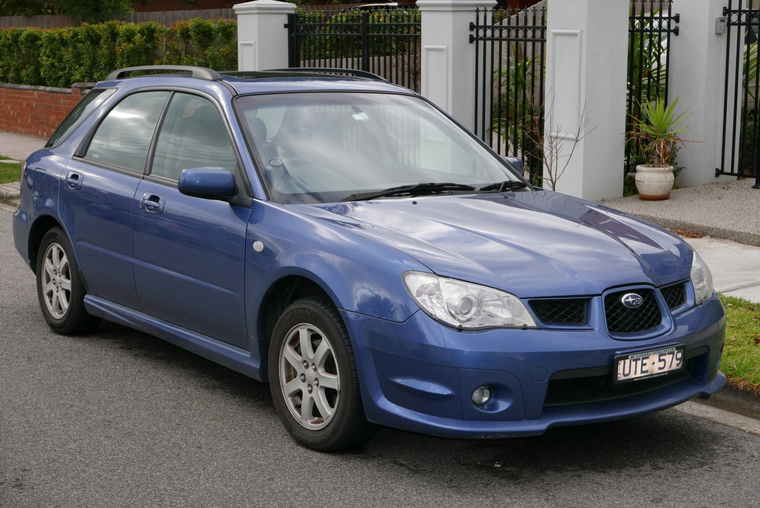 Blue station wagon with roof rails and fog lights