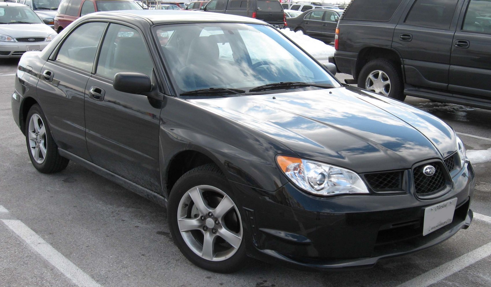 Front side view of black sedan with alloy wheels