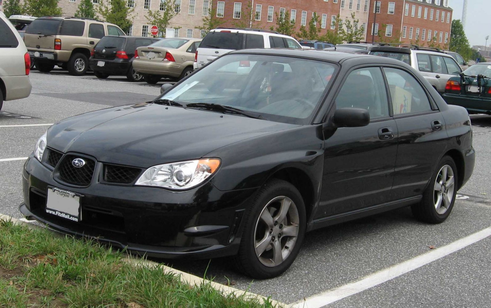 Black sedan with front side profile, signature grille and alloy wheels