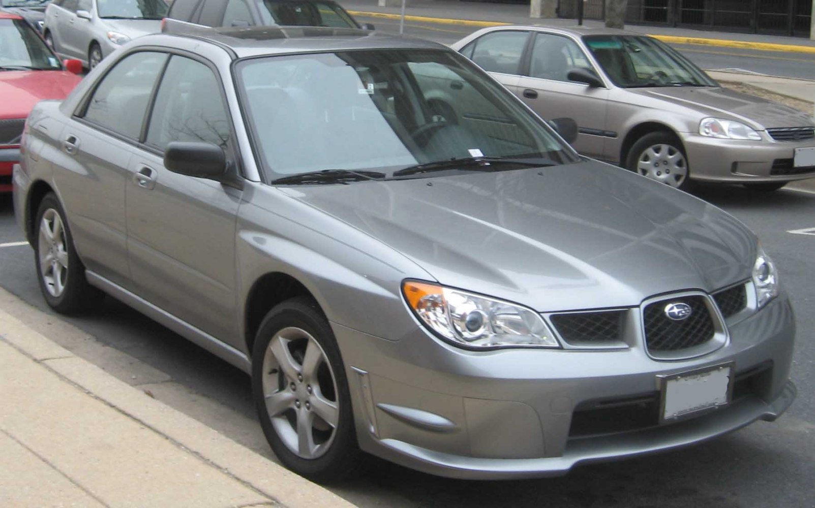 Silver front-side view of compact sedan with distinct headlights and alloy wheels