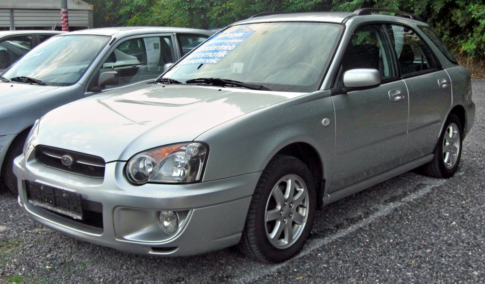 Silver station wagon with dual round headlights and alloy wheels