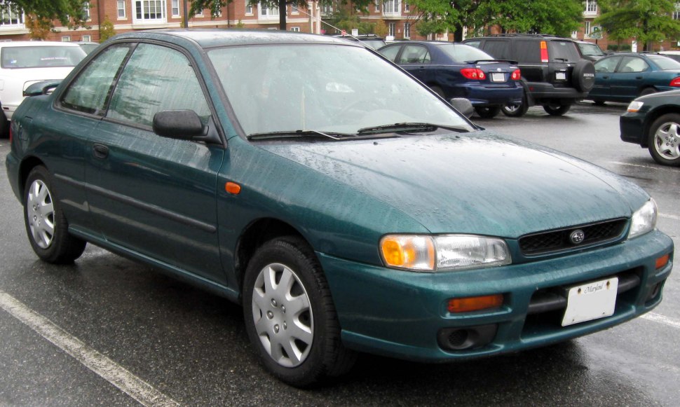 Front side view of a classic 90s sedan in green.