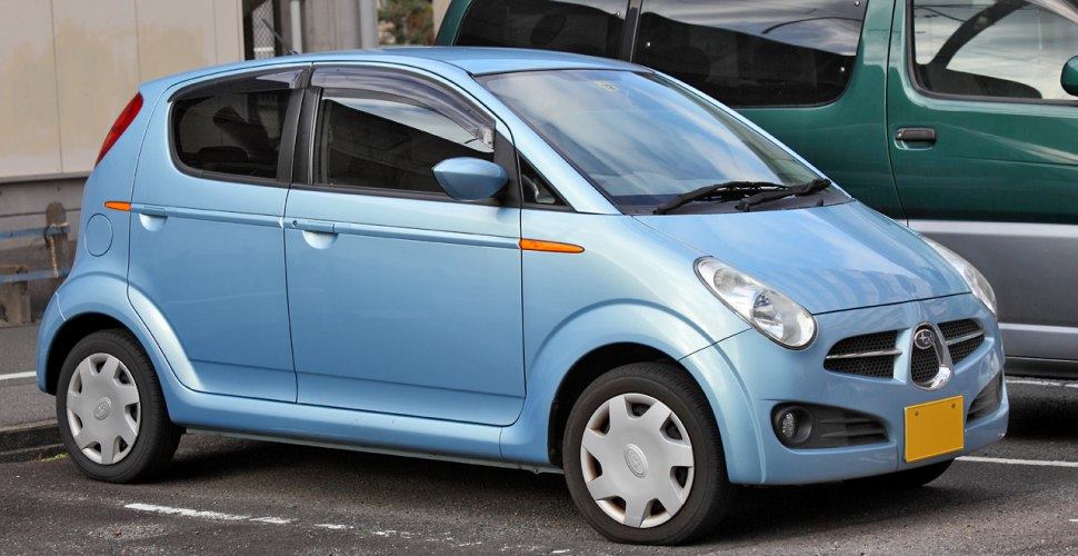 Compact hatchback with rounded headlights and small wheels