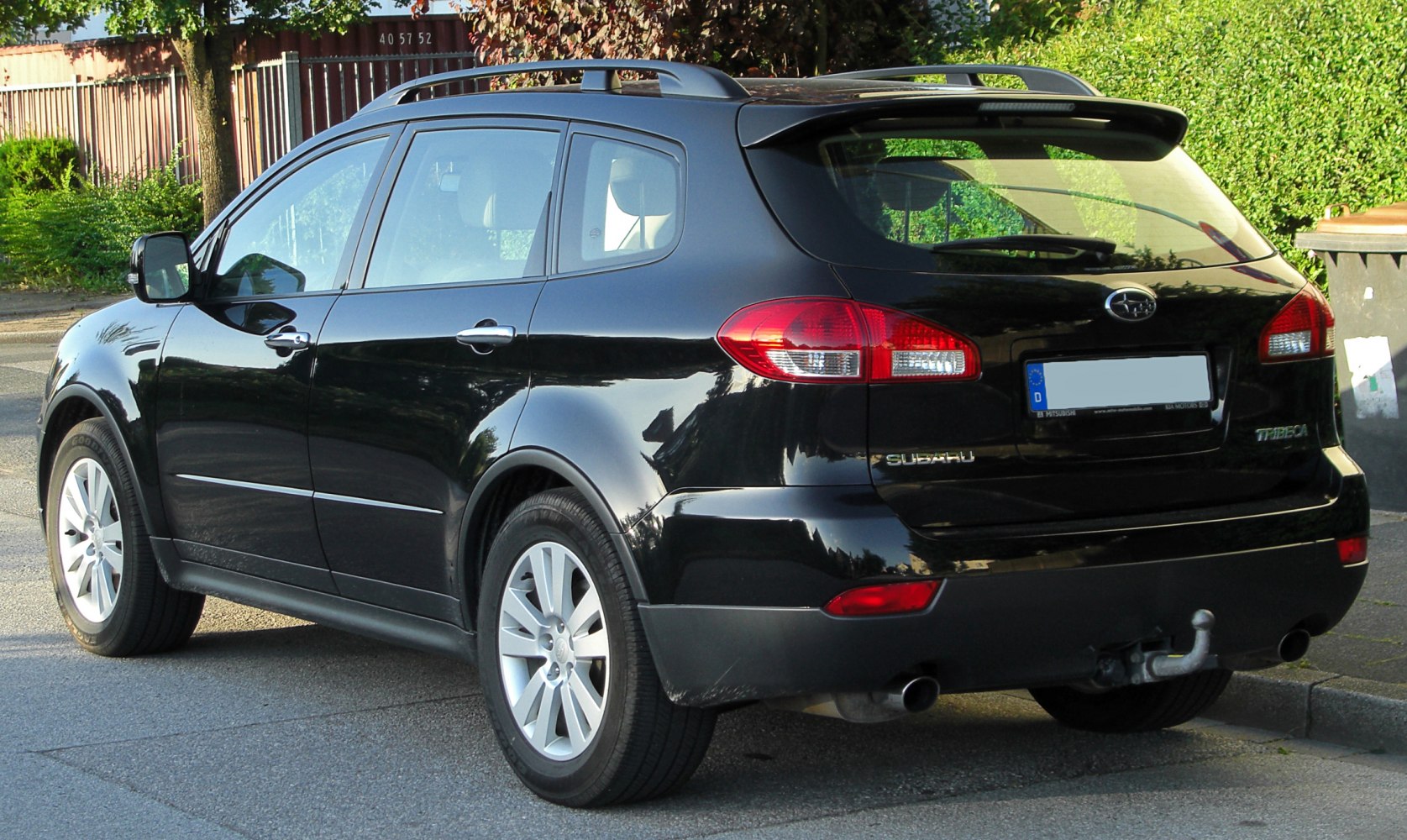 Rear view of mid-size SUV with roof rails and tow hitch