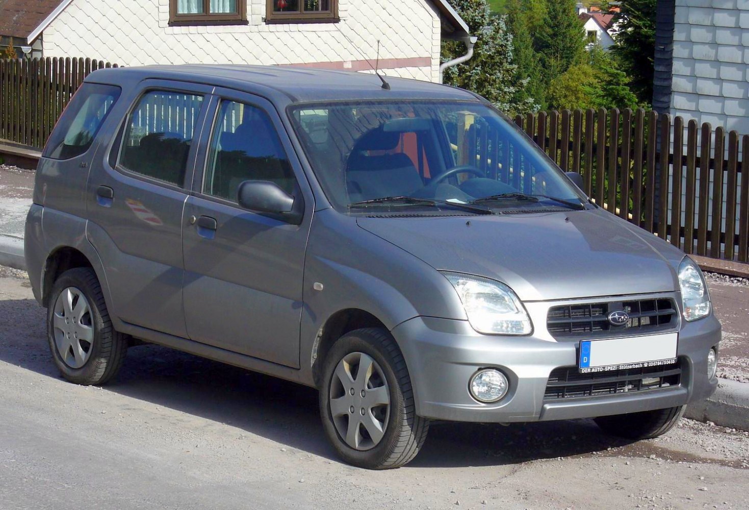 Compact hatchback with round fog lights and oval headlights.