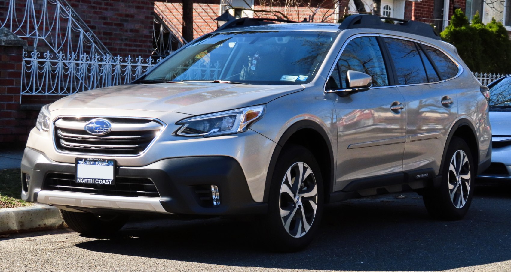 Front and side view of SUV with alloy wheels and roof racks