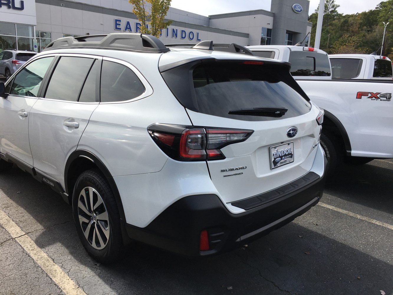 White SUV rear with roof rails and distinct taillights