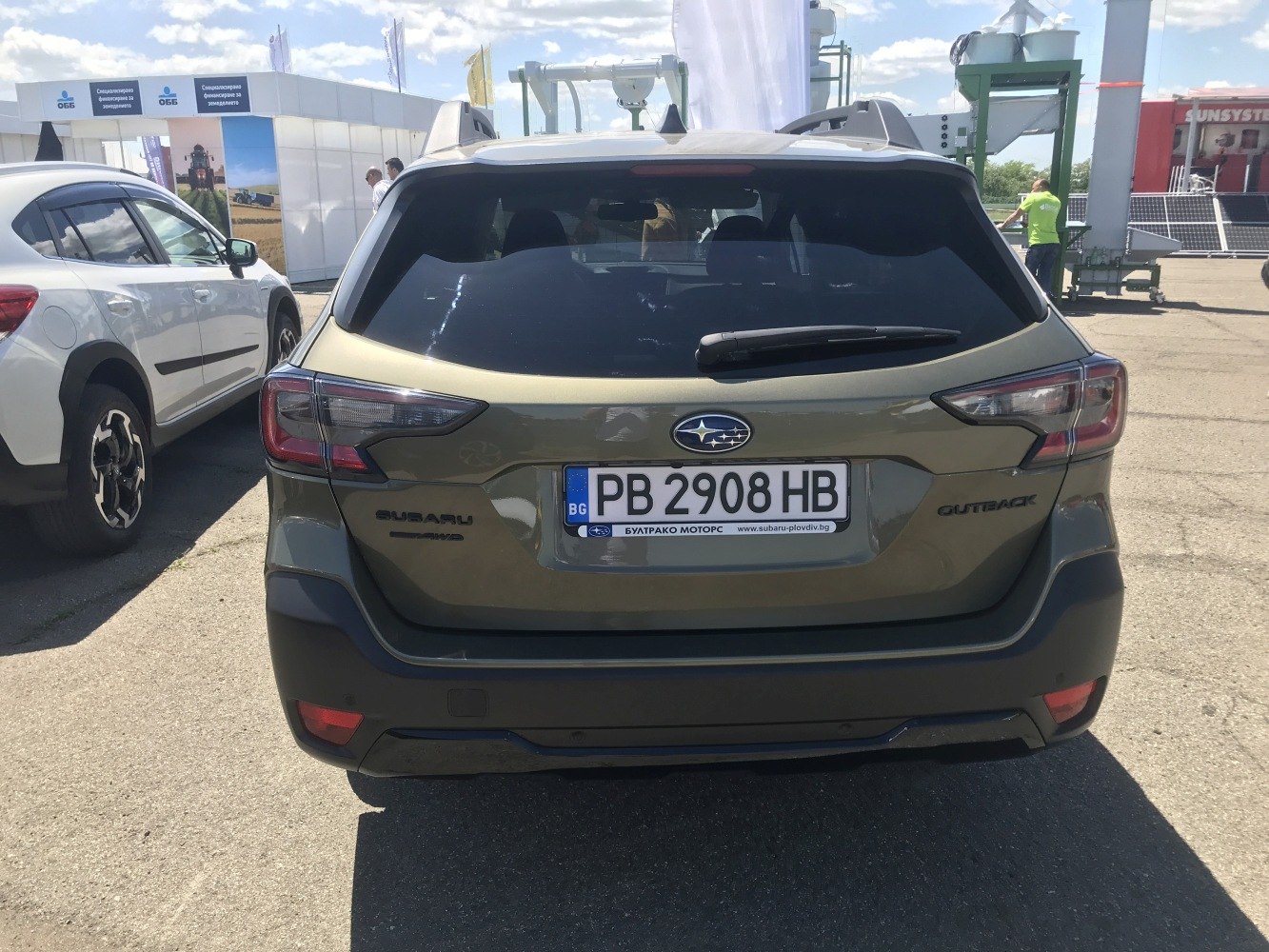 Rear view with distinct tail lights and roof rails.