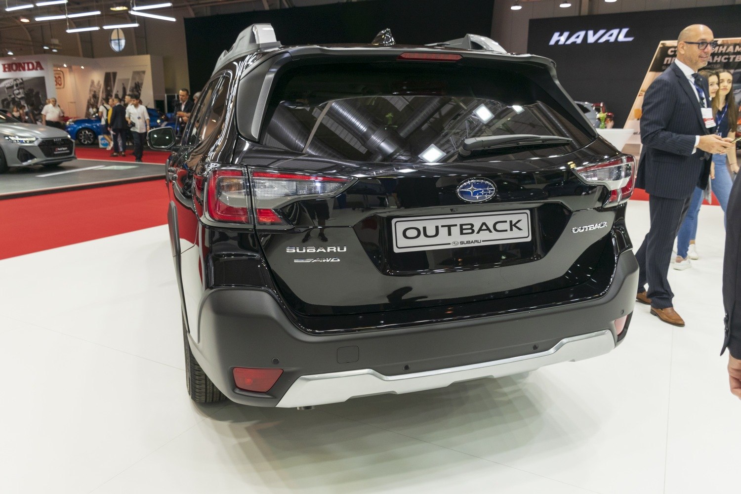 Rear view of black SUV with roof rails and AWD badge