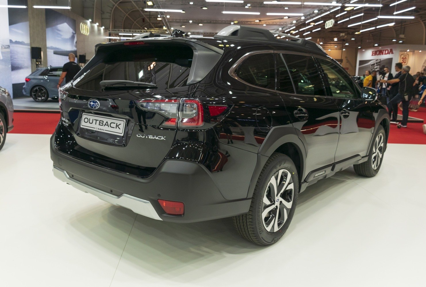 Rear-side view with tail lights, roof rails, and alloy wheels