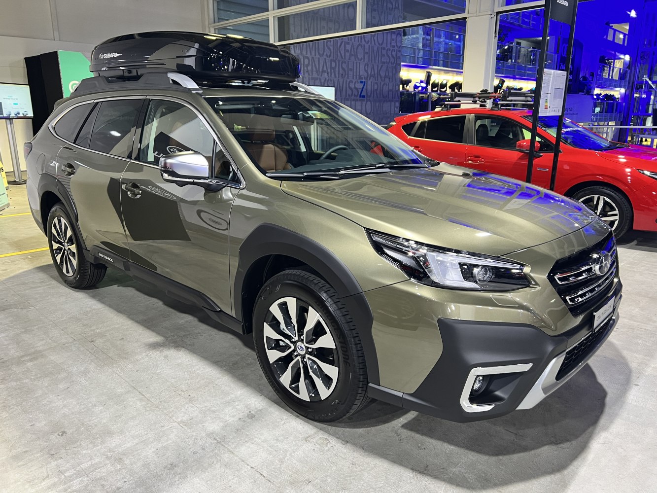 SUV with roof cargo box and rugged design features