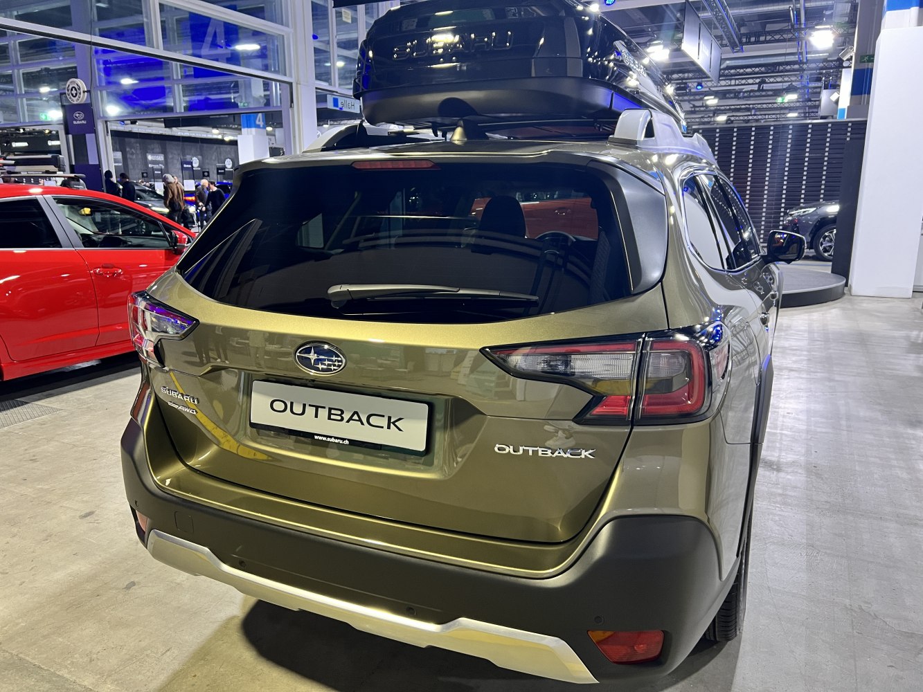 Rear view of SUV with roof cargo box and detailed tail lights