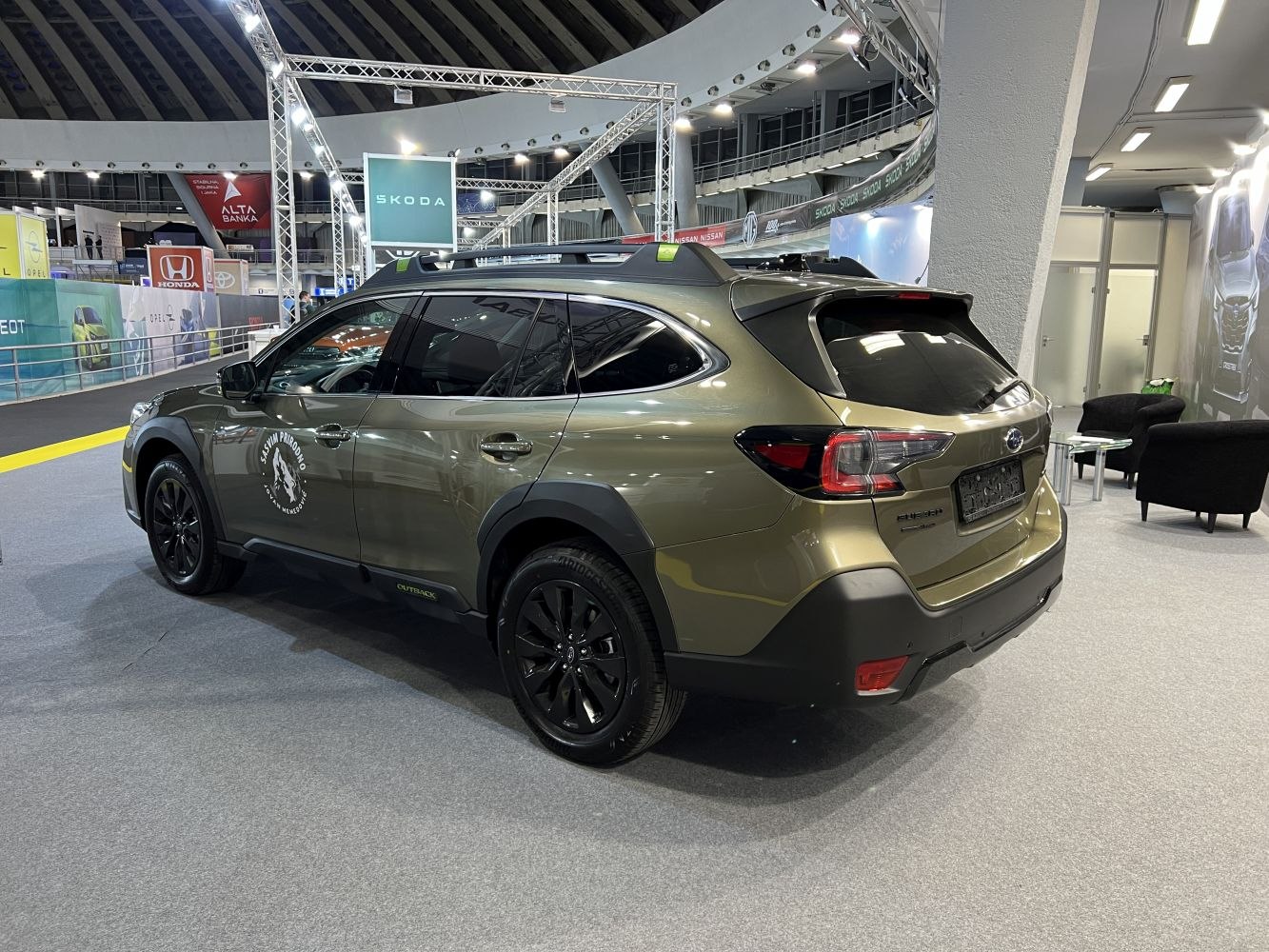 Rear side profile with roof rails and black alloy wheels.