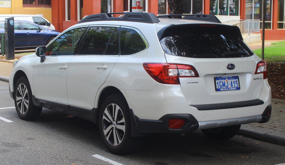 Rear and side view of white SUV with alloy wheels and roof rails